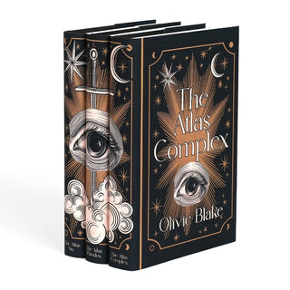 Angle shot of The Atlas Series by Olivie Blake. Front covers of jackets feature woodcut eye illustration between book title and author name surrounded by cooper colored stars and ornamental detailing.