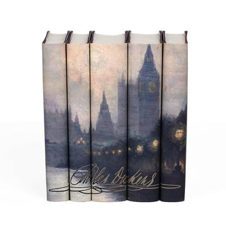 A Foggy Dickensian London scene across spines of five Dickens books streetlights glow through the fog. Charles Dickens signature stretches across bottom of all five spines 