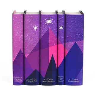 A pink and purple mountain range spans book spines set against a starry sky. Three stars sit atop the highest mountain.