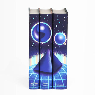 The Three-Body Problem dust jackets features blue and purple shiny orbs floating above a blue pyramid. Book title names typed across bottom of book spines in iridescent foil serif type. Spines accented with iridescent foil.