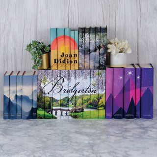 Julia Quinn Bridgerton, Sarah J Maas Universe, Joan Didion, and Jane Austen Book set from Juniper Books sitting against a white wood background.