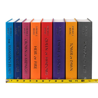 Unjacketed books in the Throne of Glass Series. Tape measure sits at base of spine displaying width of set