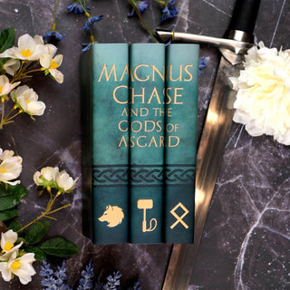 Special Edition book covers for Magnus Chase and the Gods of Asgard book set by Rick Riordan styled on a black marble background with covers by Juniper Books.
