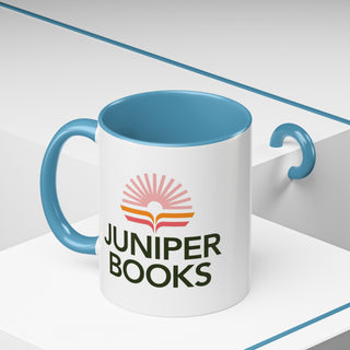 Juniper Books Logo Mug in light blue. Outside of mug is white with Black Juniper Books logo. Interior and handle are light blue.