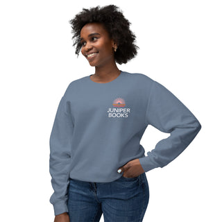 Model wearing Juniper Books Crewneck Sweatshirt in blue jean set against a white background.