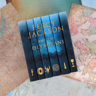 Percy Jackson and the Olympians book set with book covers sitting spines up on various maps.