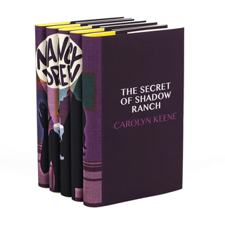 A Set of Nancy Drew books with modern dust jackets, viewed at an angle to showcase an individual book. The spine continues the collective illustration, while the front cover of the featured book, The Secret of Shadow Ranch, has a minimalist design with the title and author’s name prominently displayed in white and purple text on a deep purple background. The vibrant yellow of the page edges adds a pop of contrast to the overall sleek and sophisticated design.