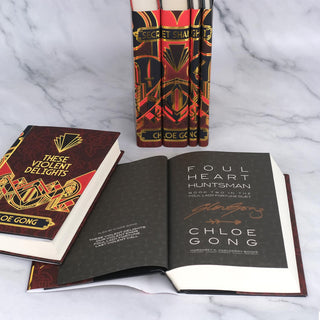 Author signature on the title page of These Violent Delights by Chloe Gong, with book jackets designed by Juniper Books.