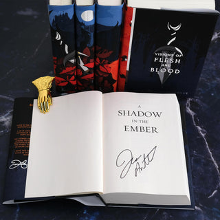 Title page of A Shadow in the Ember signed by Author Jennifer Armentrout. Open book sits in front of jacketed spines of other books in the series.