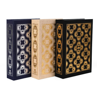 A set of three dust jacket boxes designed by Juniper Books, resembling hardcover book spines. Each box features intricate, symmetrical patterns in metallic colors on the spine and covers—silver on a navy blue box, gold on a beige box, and gold on a black box. The Juniper Books logo is displayed at the bottom of each spine.