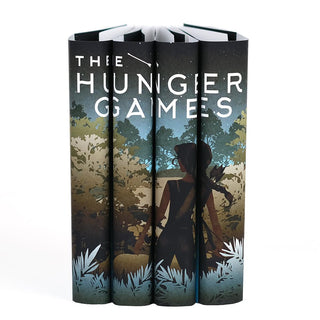 A girl with a bow and arrow standing in front of dense foliage. The Hunger Games collectible custom dust jackets from Juniper Books.