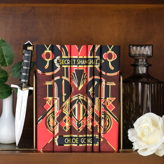 Limited Edition Shanghai Secrets Book Set by Chloe Gong, styled on a dark wooden book shelf with eye-catching book covers designed by Juniper Books.