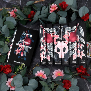 Limited Edition Hades x Persephone Saga Book Set by Scarlett St. Clair styled on a a black marble background with eye catching book covers designed by Juniper Books.