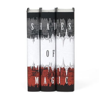 Dust jackets feature a black, grey, white, and red city layered against a white map background. Shades of Magic typed across spines in white serif font.