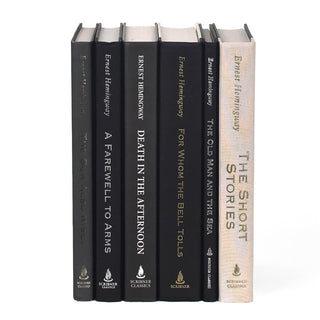 Shot of unjacketed books in the Ernest Hemingway book set from Juniper Books. Books are black and white and the spines have author name and book titles with publisher logo at the bottom of the spine.
