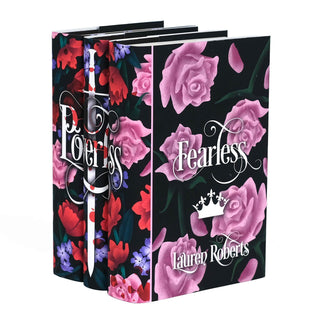 A set of three hardcover books set at an angle featuring a dark floral dust jacket design with red, pink, and purple flowers against a black background. The spines display the word 'Powerless' in an elegant, swirling white font overlaid on a white sword with red blood splatters. The front cover of the book on the right displays the title 'Fearless' in a matching white script, along with a small white crown illustration and the author's name, Lauren Roberts, in a decorative font.