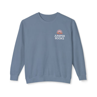 Juniper Books Crewneck Sweatshirt in Blue Jean. Juniper Books logo and company name on left chest.