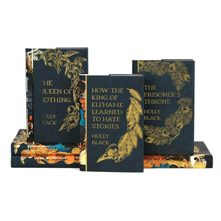 Covers of The Limited Edition Folk of the Air Book Set sitting in a tiered stack . Covers feature book title and author name and illustrations of apple and oak branches in gold foil.