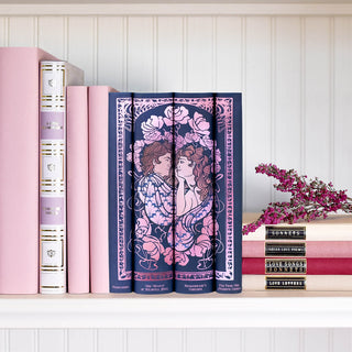 Our original, hand-drawn design was inspired by Art Nouveau and covers heirloom-quality hardbacks published by Everyman's Library. Each book is wrapped in custom indigo and pink jackets featuring a design depicting two lovers gazing adoringly at each other.