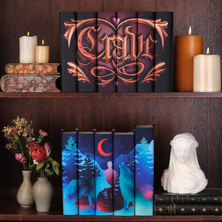 Install shot of Crave Series on wooden bookcase set above Twilight Red Moon Set from Juniper Books. Both sets surrounded by candles, antique books, and dried flowers.