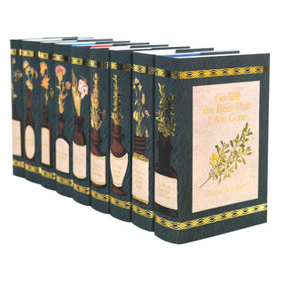 Angled view displaying spine and cover design of Limited Edition Outlander Book Set by Diana Gabaldon wrapped in Juniper Books collectible book covers.