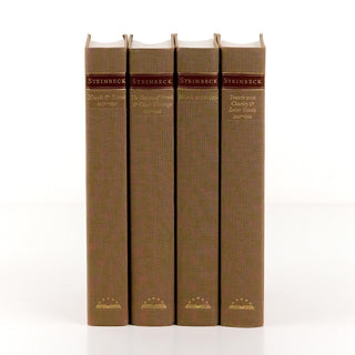 Unjacketed John Steinbeck Book from Library of America showing original spines beneath Juniper Books book covers.