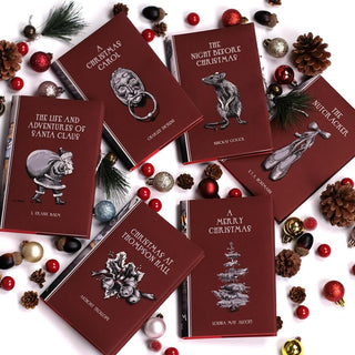 This festive set of novels is the perfect way to celebrate your favorite year-end traditions. Book Set, gift, trade, Christmas shopping. Deep red covers feature black and white illustrations rat, ballet slippers, door knockers, santa, mistletoe, a christmas tree 