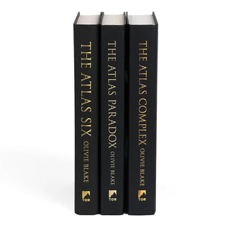 Unjacketed shot of The Atlas Series book spines. Black book spines feature book title, author name, and publisher logo in gold.