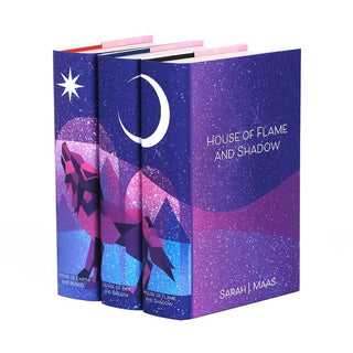 Angle shot of dust jackets on Crescent City books. Front cover of jackets feature pink and purple hues over white stars. Covers feature author name and book title in white sans serif font.
