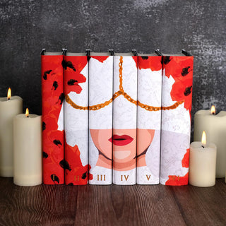 Special Edition book covers for Blood adn Ash Book Set by Jennifer L. Armentrout styled against a cement background surrounded by lit candles with covers by Juniper Books.