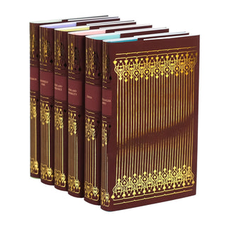 Angled view of a Jane Austen book set featuring six novels with deep red covers, ornate gold embellishments, and titles embossed in gold on the spines. The front covers showcase intricate gold foil filigree designs. Books are elegantly arranged to highlight both spine and cover details.