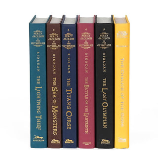 unjacketed book spines in the Percy Jackson and the Olympians series. Books come in blue, brown, navy, red, black, and yellow.