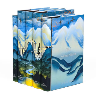 Angled shot of Lord of the Rings set from Juniper Books. Jacket cover feature book title and author name in silver foil against a blue mountain scape.