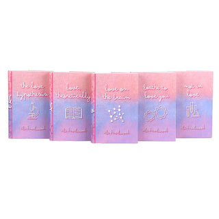 A set of five Ali Hazelwood novels in custom designed book jackets featuring a gradient of pink, blue, and purple photographed in a spread on a white background. The titles of each novel's cover are centered in the middle top of the design in playful white lowercase cursive. Below each title, there are various STEM-related iconography illustrated in clean white lines. The design has a fun and flirty feel that fits right in with Ali Hazelwood's STEMinist novels.