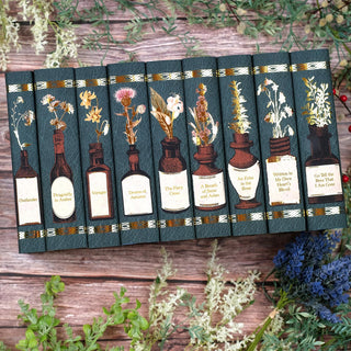  Limited Edition Book Set for Outlander Series by Diana Gabaldon styled on a wood background with eye catching book covers designed by Juniper Books.