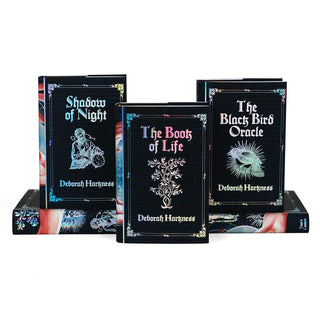 Tier arrangement of front covers of All Souls Series. Front covers feature book title, author name, and symbol related to book surrounded by ornamental frame.