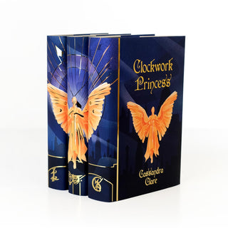 Angled view of the spines and cover design of the signed Infernal Devices Limited Edition book set wrapped in Juniper Books collectible book covers.