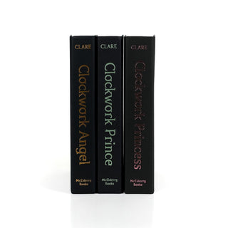 Unjacketed Infernal Devices books by Cassandra Clare showing original spines beneath Juniper Books book covers.
