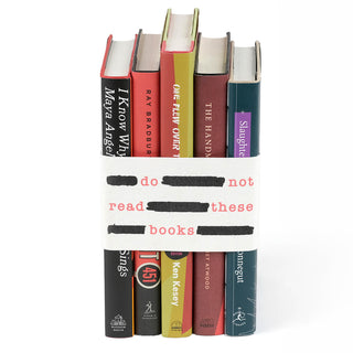 To showcase the common themes that connect these powerful works, we have designed a hand-sewn canvas book band that binds these novels into a single set. This book band proudly displays the books' shared attributes while still featuring the iconic original covers of each book.